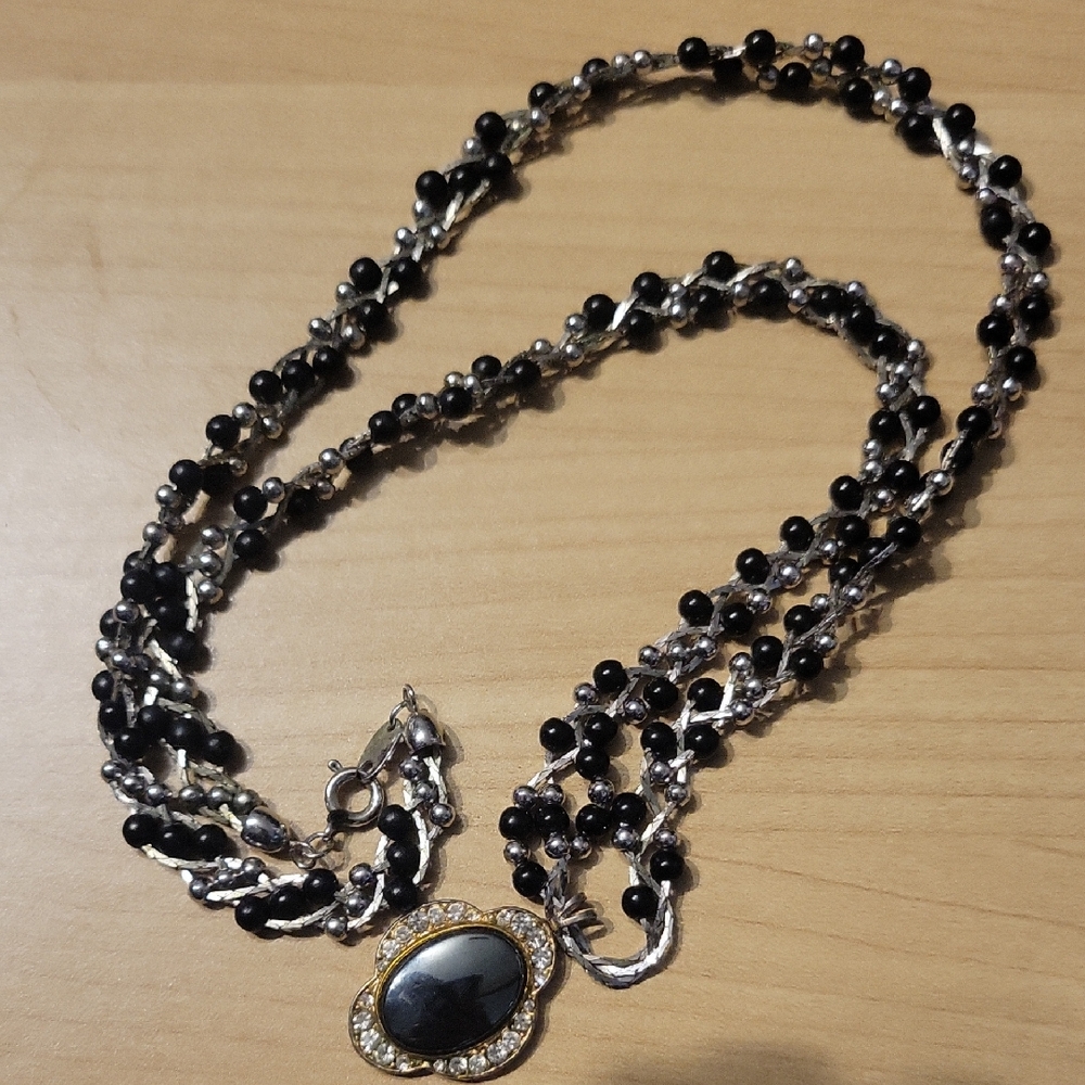 Elegant Black and Silver Necklace with Gold Accents